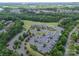 Overhead view of a parking lot, the clubhouse, and the golf course in a community near the water at 16507 Palisades Commons Dr, Charlotte, NC 28278