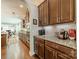 Modern kitchen featuring stainless steel appliances, granite countertops, hardwood floors, and a view into the dining area at 16507 Palisades Commons Dr, Charlotte, NC 28278