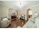 Elegant living room featuring hardwood floors, stylish furnishings, and a decorative chandelier at 16507 Palisades Commons Dr, Charlotte, NC 28278