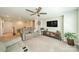 Cozy living room with reclining sofa, media console, and lots of natural light at 16507 Palisades Commons Dr, Charlotte, NC 28278