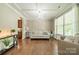 Inviting living room with hardwood floors, tray ceiling, decorative lighting, and large windows, offering a comfortable living space at 16507 Palisades Commons Dr, Charlotte, NC 28278