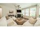 Bright living room features a cozy fireplace, large sectional sofa, and lots of natural light at 16507 Palisades Commons Dr, Charlotte, NC 28278