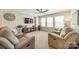 Comfortable living room featuring reclining sofas, entertainment center, and lots of windows at 16507 Palisades Commons Dr, Charlotte, NC 28278