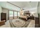 Spacious main bedroom featuring tray ceiling, ceiling fan, and large decorative rug at 16507 Palisades Commons Dr, Charlotte, NC 28278