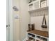 Organized mudroom with built-in bench, storage shelves, and coat hooks at 16507 Palisades Commons Dr, Charlotte, NC 28278