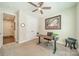Bright office with a ceiling fan, desk, and comfortable seating at 16507 Palisades Commons Dr, Charlotte, NC 28278