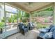 Screened porch showing landscape views, comfortable seating, and ceiling fan at 16507 Palisades Commons Dr, Charlotte, NC 28278