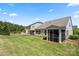 Expansive backyard featuring lush lawn, fenced perimeter, and a charming screened-in porch at 199 Blossom Ridge Dr, Mooresville, NC 28117