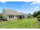 Well-manicured backyard showcasing lush greenery, a fenced perimeter, and an inviting screened porch at 199 Blossom Ridge Dr, Mooresville, NC 28117