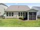 Lush backyard view, showcasing the home's screened-in porch and meticulously maintained lawn at 199 Blossom Ridge Dr, Mooresville, NC 28117