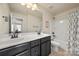 Bathroom featuring double sinks, framed mirror, and a shower-tub combo with stylish curtain at 199 Blossom Ridge Dr, Mooresville, NC 28117