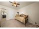 Neutral bedroom with daybed, full length mirror, and door to ensuite bathroom at 199 Blossom Ridge Dr, Mooresville, NC 28117