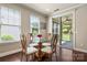 Bright dining area with decorative chairs, a glass table, and natural light streaming in at 199 Blossom Ridge Dr, Mooresville, NC 28117