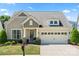 Charming home with a manicured lawn, complemented by a two-car garage and inviting front porch at 199 Blossom Ridge Dr, Mooresville, NC 28117