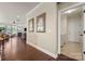 Hallway view leading to the living room with artwork on the walls and laundry room access at 199 Blossom Ridge Dr, Mooresville, NC 28117