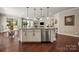 The white kitchen island is fitted with stainless steel appliances and granite countertops at 199 Blossom Ridge Dr, Mooresville, NC 28117