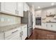 A modern kitchen features stainless steel appliances and white cabinets with granite countertops at 199 Blossom Ridge Dr, Mooresville, NC 28117
