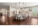 A gourmet kitchen features a granite island, stainless appliances, and sleek white cabinetry at 199 Blossom Ridge Dr, Mooresville, NC 28117