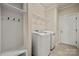 Well-organized laundry room with modern appliances, storage shelves, and a convenient layout at 199 Blossom Ridge Dr, Mooresville, NC 28117