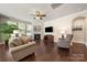 Cozy living room with a fireplace, large windows, and comfortable seating area at 199 Blossom Ridge Dr, Mooresville, NC 28117