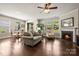 Open-concept living area with fireplace, multiple windows, and direct access to the outdoor space at 199 Blossom Ridge Dr, Mooresville, NC 28117