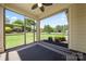 Inviting screened porch with ceiling fan and a view of the lush, green backyard at 199 Blossom Ridge Dr, Mooresville, NC 28117