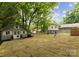 Backyard view showcasing both the main house and a separate outbuilding at 2009 Edgewater Dr, Charlotte, NC 28210