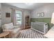 Charming Bedroom with natural light, themed decor, and a cozy rocking chair at 2009 Edgewater Dr, Charlotte, NC 28210