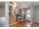 Inviting entryway with hardwood floors, a decorative mirror, and a staircase leading upstairs at 2009 Edgewater Dr, Charlotte, NC 28210