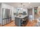 Modern kitchen boasts stainless steel refrigerator and a central island with pendant lighting at 2009 Edgewater Dr, Charlotte, NC 28210
