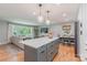 Open kitchen and living area featuring a large island, stainless appliances, and natural light at 2009 Edgewater Dr, Charlotte, NC 28210