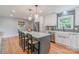 Bright kitchen features an island with seating, stainless steel appliances, and white cabinetry at 2009 Edgewater Dr, Charlotte, NC 28210