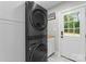 Convenient laundry room featuring modern appliances and ample cabinet space for storage at 2009 Edgewater Dr, Charlotte, NC 28210