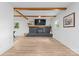 Bright living room featuring a fireplace, wooden beams, and wood flooring at 2009 Edgewater Dr, Charlotte, NC 28210