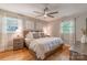 Tranquil main bedroom with hardwood floors, two windows, and neutral decor at 2009 Edgewater Dr, Charlotte, NC 28210