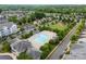 Aerial view of a community featuring a sparkling pool, playground, parking, and lush green spaces for outdoor enjoyment at 2151 Belle Vernon Ave, Charlotte, NC 28210