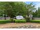 Community entrance sign with manicured landscaping and mature trees at 2151 Belle Vernon Ave, Charlotte, NC 28210