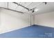 A spacious two-car garage with blue epoxy floor and plenty of storage space at 2151 Belle Vernon Ave, Charlotte, NC 28210