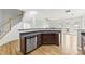 Kitchen with stainless steel dishwasher and ample cabinet space, adjacent to an open living area, enhancing functionality and flow at 2151 Belle Vernon Ave, Charlotte, NC 28210