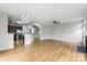 Open-concept living room with hardwood floors and stylish light fixture, creating a bright and inviting space for gatherings at 2151 Belle Vernon Ave, Charlotte, NC 28210