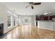 Spacious living room with hardwood floors, a fireplace, and adjacent kitchen area that is perfect for entertaining and gatherings at 2151 Belle Vernon Ave, Charlotte, NC 28210