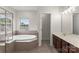 Inviting bathroom with a garden tub and a separate vanity area at 2151 Belle Vernon Ave, Charlotte, NC 28210