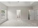 Spacious main bedroom with tray ceiling and carpet and view to bathroom and closet at 2151 Belle Vernon Ave, Charlotte, NC 28210
