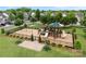 Aerial view of a community playground, featuring slides, swings, and picnic tables at 2151 Belle Vernon Ave, Charlotte, NC 28210