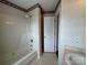 Classic bathroom with a shower-tub combo and decorative wallpaper at 2504 Faircroft Way, Monroe, NC 28110