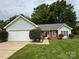 Charming single-story home featuring a well-manicured lawn, attached garage, and inviting front entrance at 2504 Faircroft Way, Monroe, NC 28110