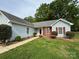 Inviting exterior view showcasing manicured lawn, walkway, and charming details of this beautiful single story home at 2504 Faircroft Way, Monroe, NC 28110