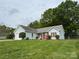 View of the exterior of a single story home with blue siding, shutters, and a well-manicured front lawn at 2504 Faircroft Way, Monroe, NC 28110