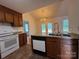 Bright kitchen featuring granite counters, an island with sink, and white appliances at 2504 Faircroft Way, Monroe, NC 28110