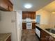 Well-designed kitchen with granite countertops, wood cabinets, updated appliances and view to the living room at 2504 Faircroft Way, Monroe, NC 28110